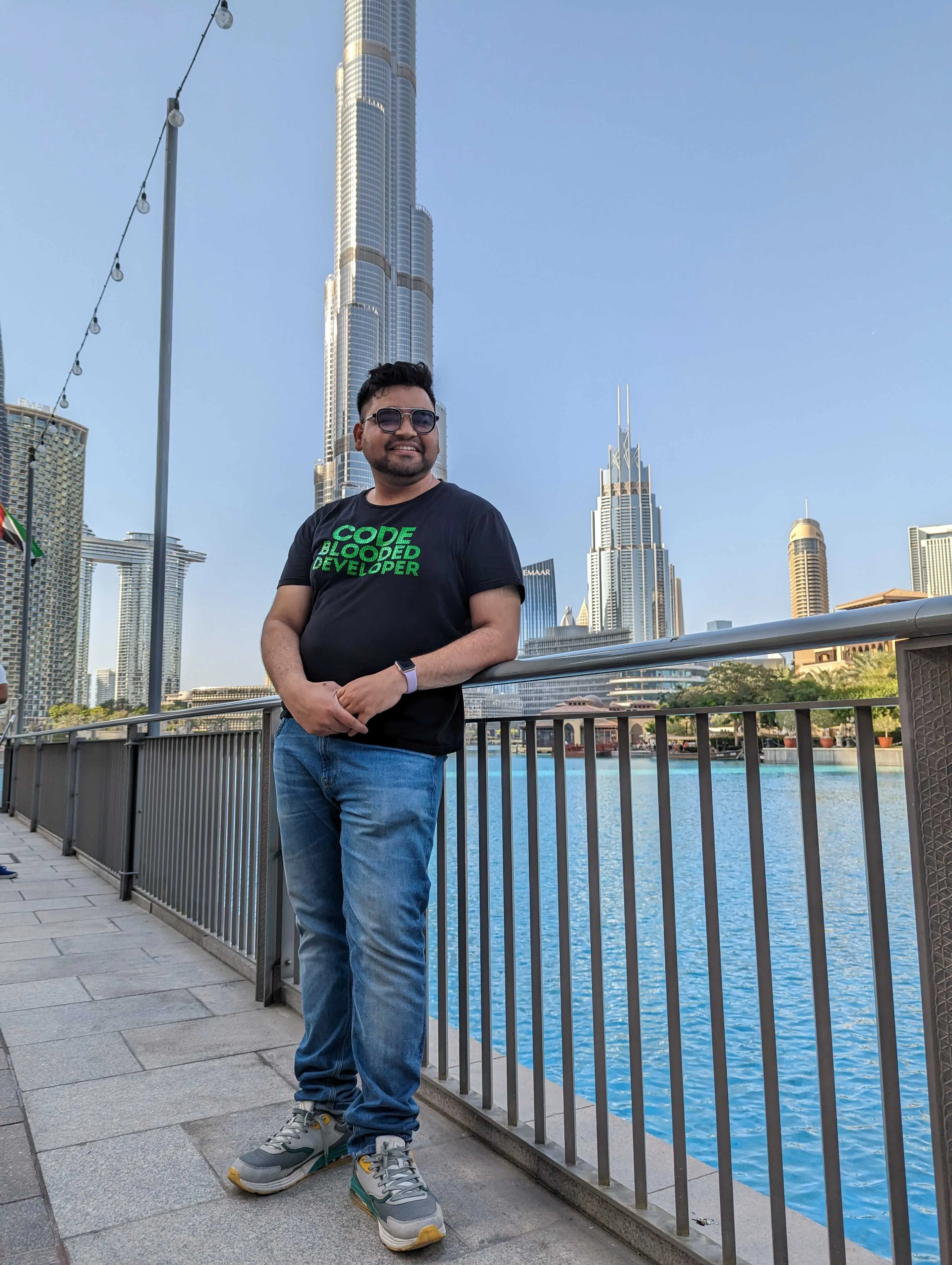 Standing by the water with the Burj Khalifa behind