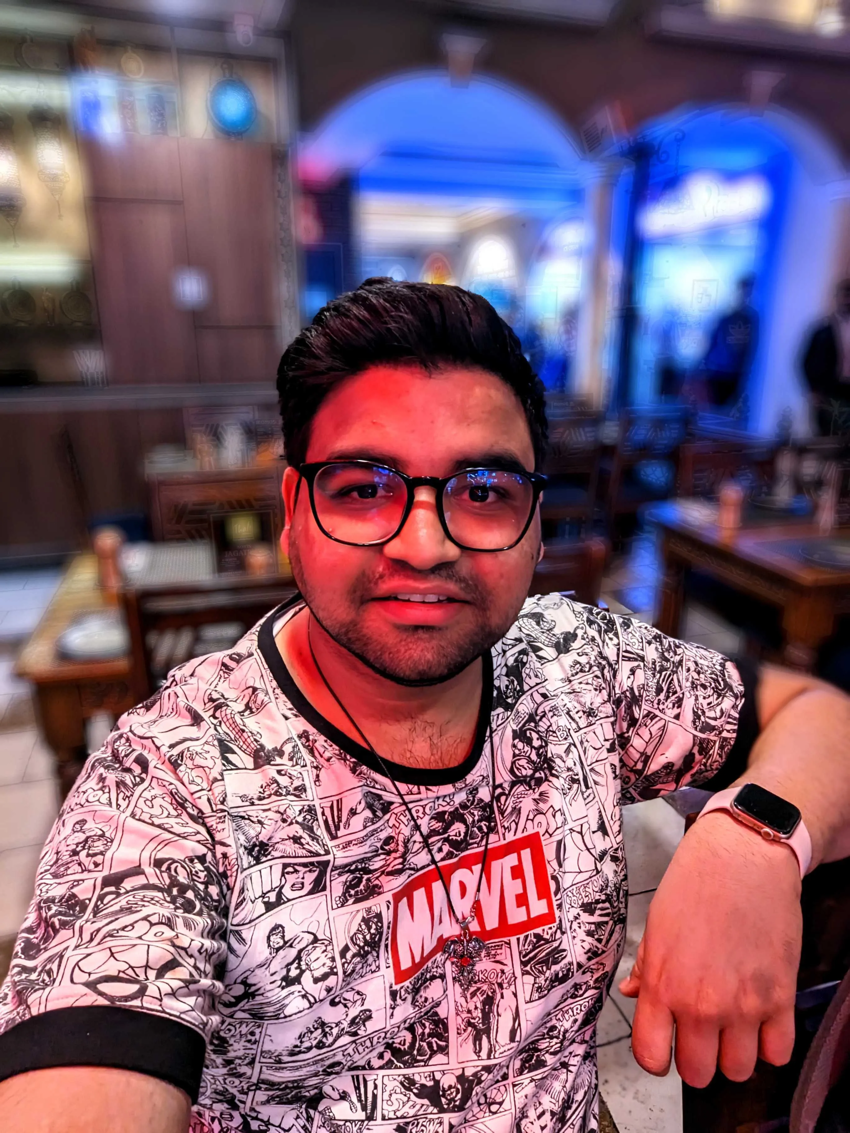 At a restaurant in a Marvel comic print shirt