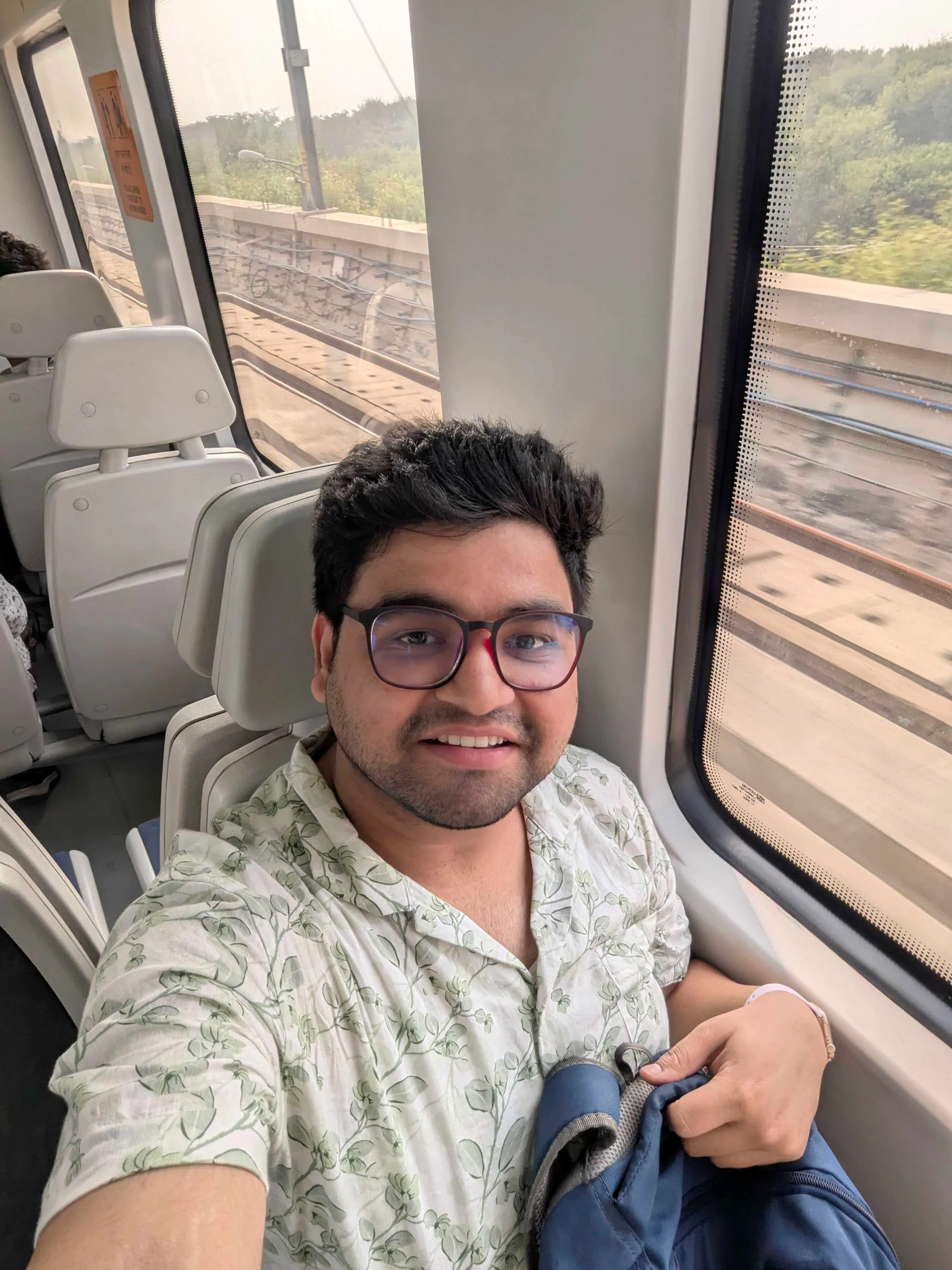 On a train beside the window, watching the track go past